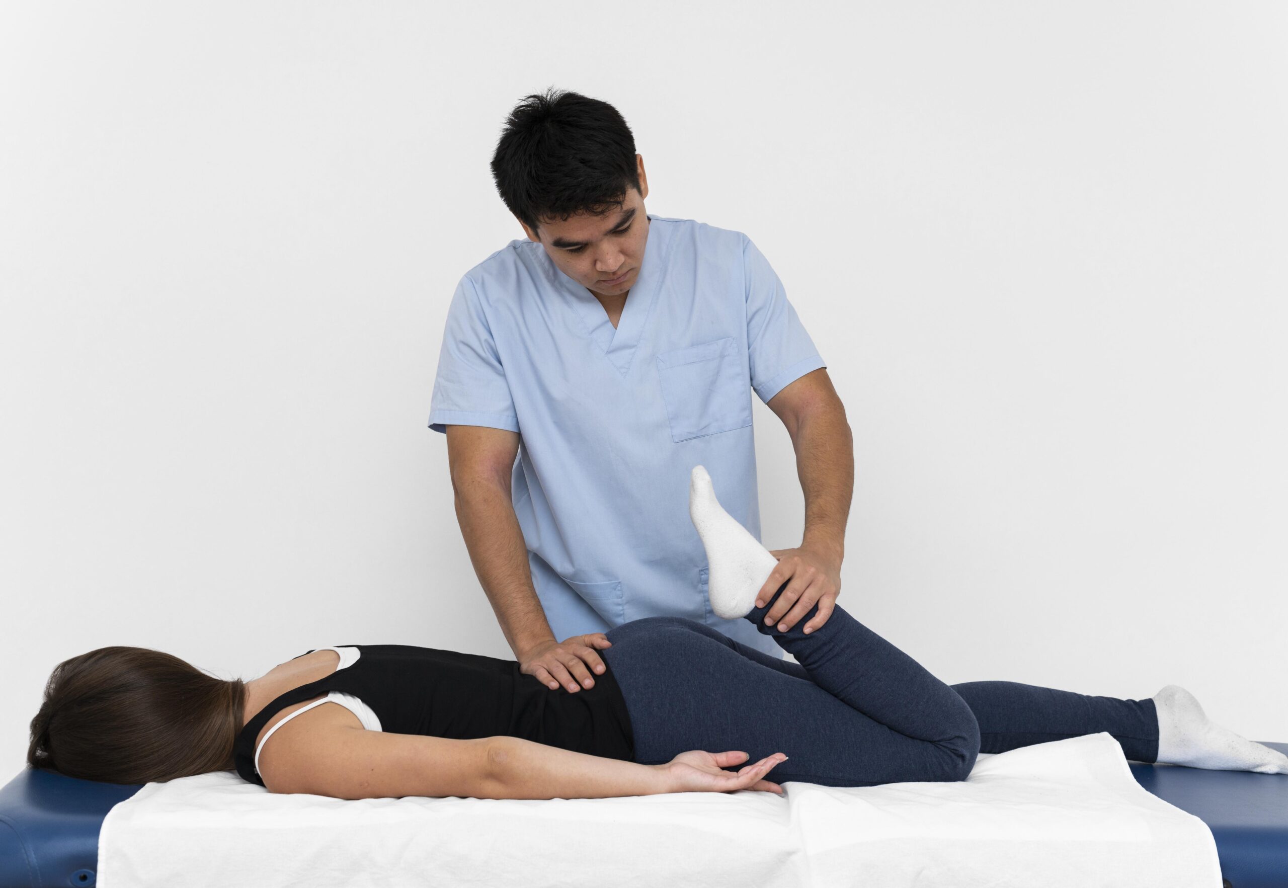 front-view-physiotherapist-doing-leg-exercises-with-woman