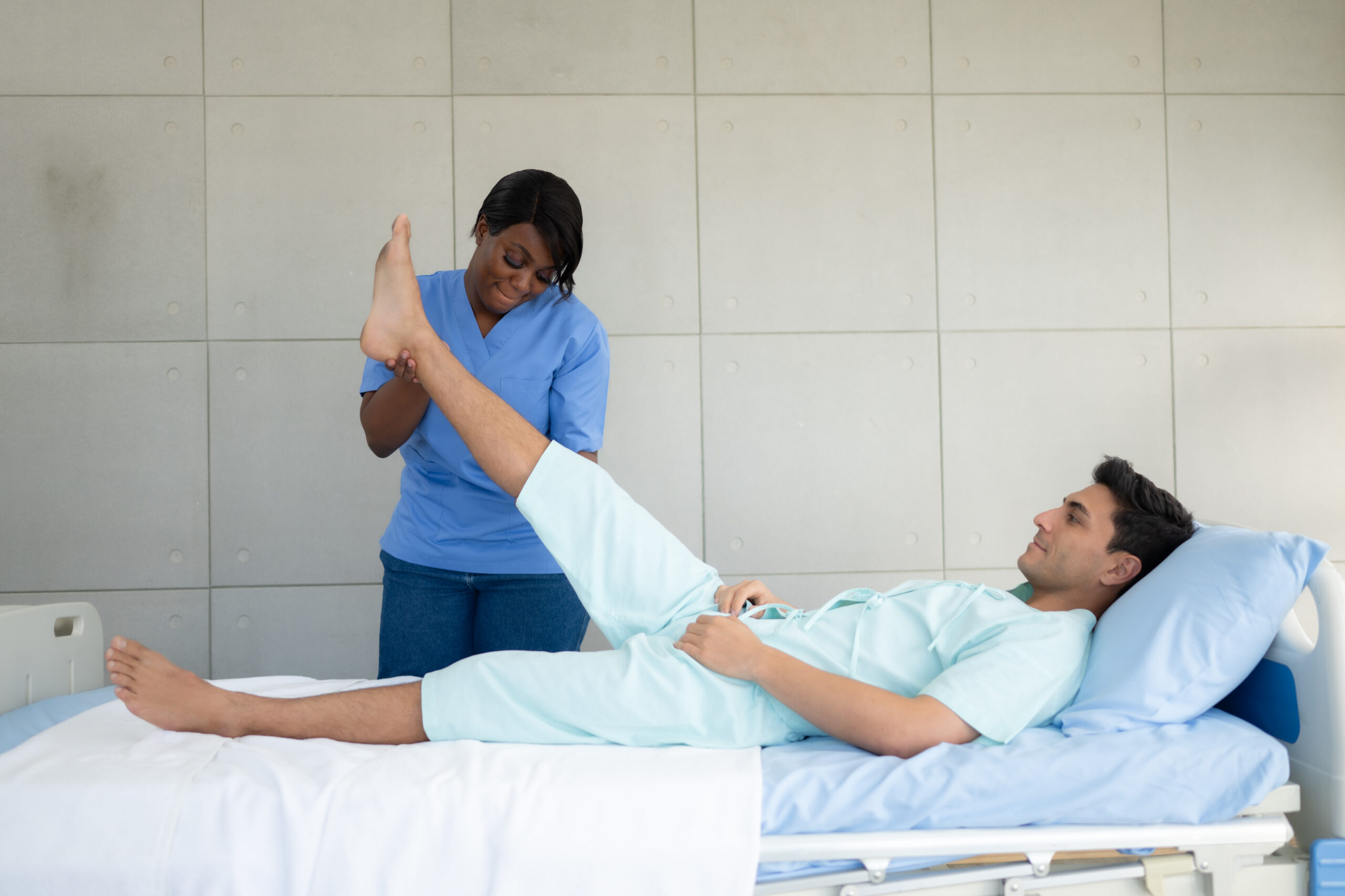 Physiotherapist doing leg massage to patient in the medical offi