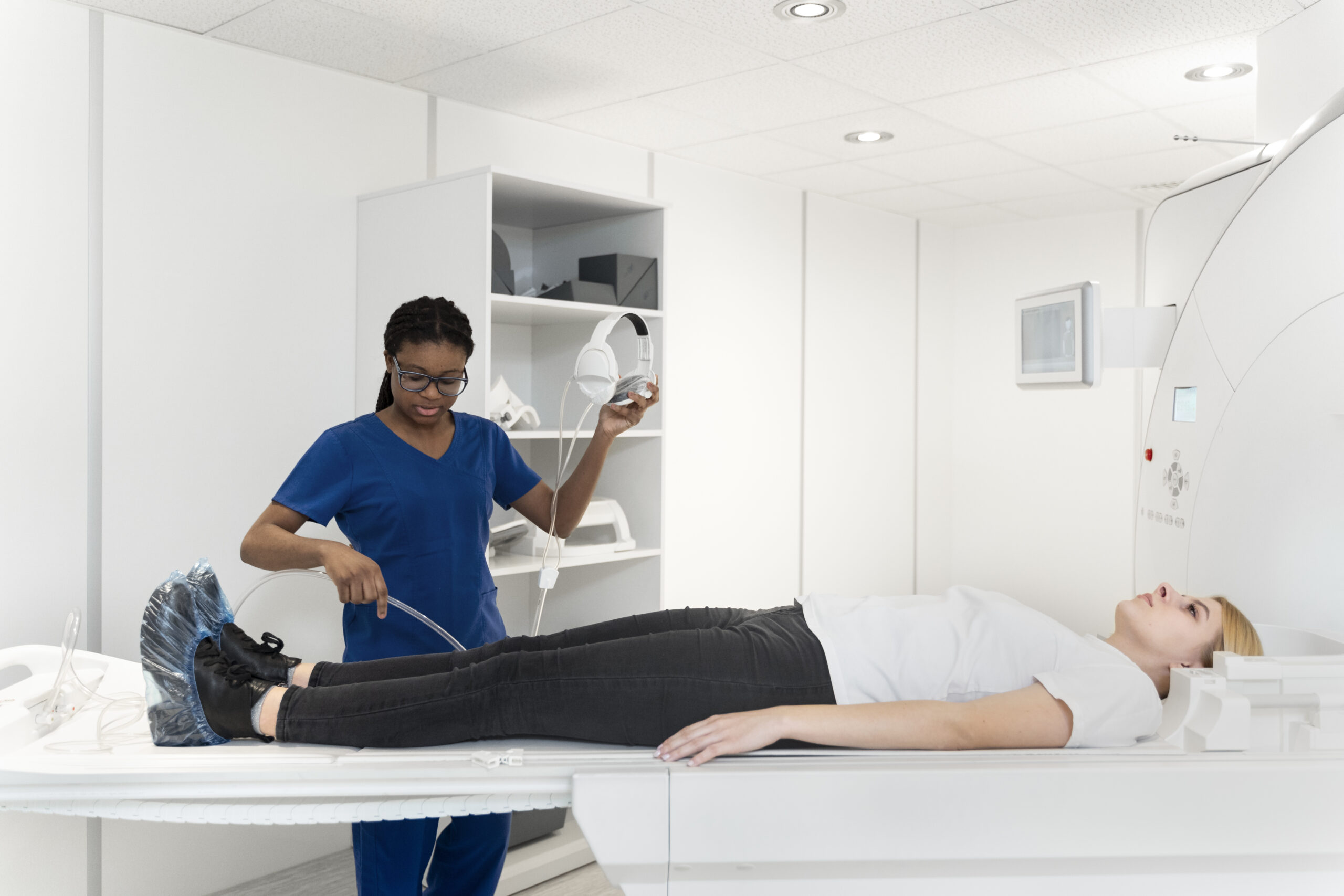 Diverse female physiotherapist helping senior male patient in wheelchair using dumbbells, copy space. Hospital, medical and healthcare services.