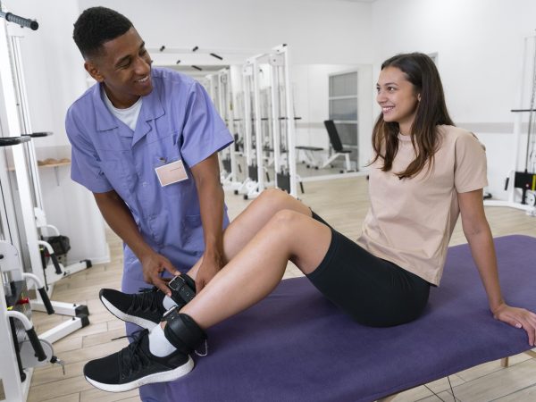 medical-assistant-helping-patient-with-physiotherapy-exercises
