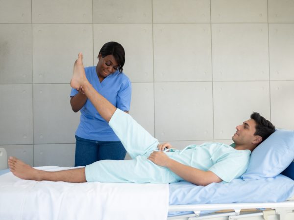 Physiotherapist doing leg massage to patient in the medical offi